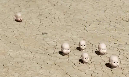 Doll heads in desert