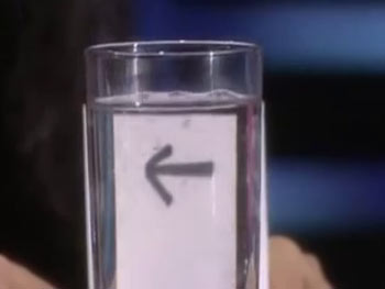 arrow behind glass of water