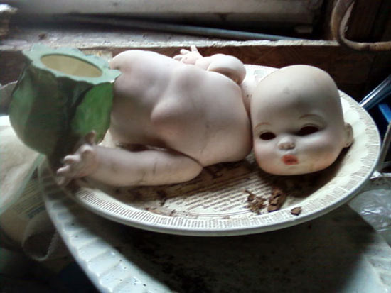 dismembered baby doll on plate