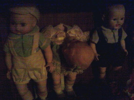 three baby dolls, middle is broken