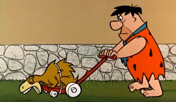Fred Flintstone mowing lawn