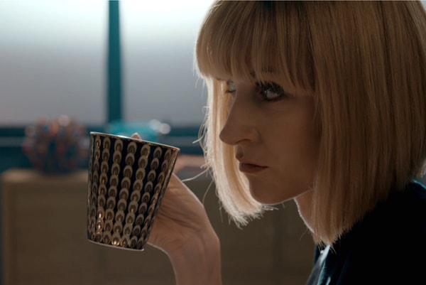 Miss Quill sipping tea