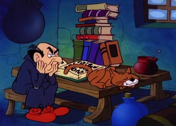 Gargamel with sleeping Azrael next to a pile of books