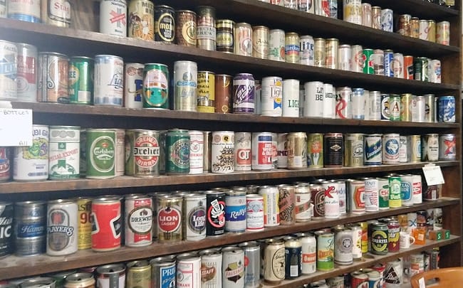 Bookshelf full of empty beer cans