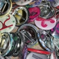 Pile of pinback buttons with letters on them